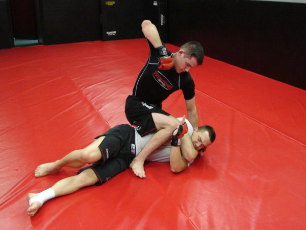 Coach James Clingerman demonstrating the gift-wrap position in Mixed Martial Arts
